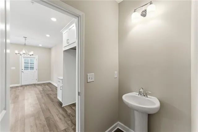a bathroom with a sink mirror and shower