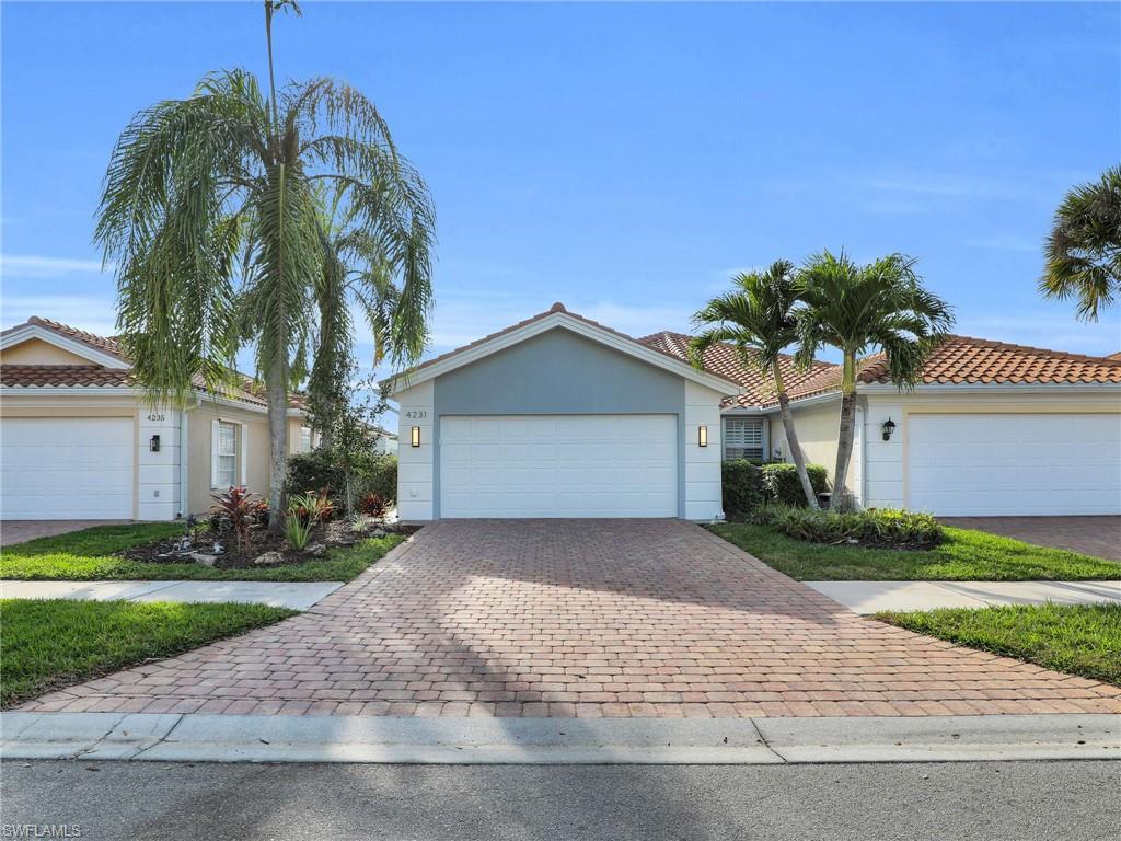 4231 Redonda Lane Naples, FL 34119 - Photo 1 of 42 a front view of a house with a yard and garage