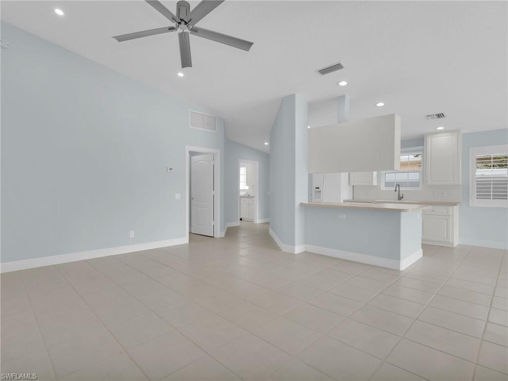 4231 Redonda Lane Naples, FL 34119 - Photo 11 of 42 a view of an empty room and a kitchen
