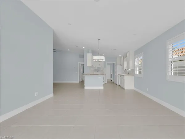 a view of a floor to ceiling window and an ocean view