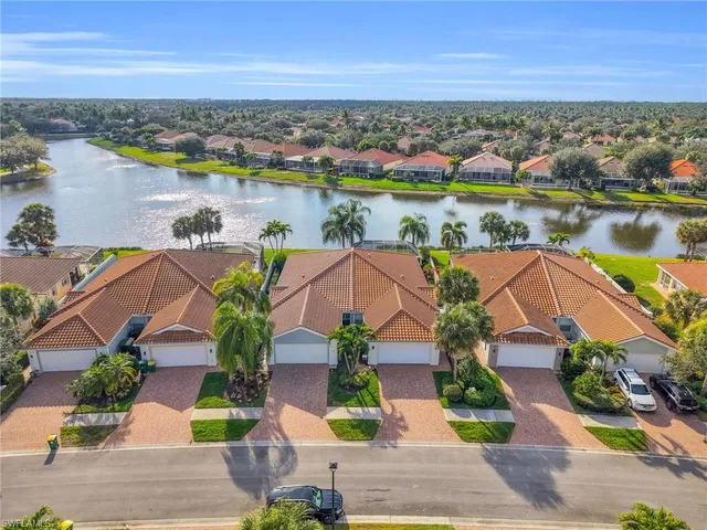 an aerial view of residential houses with outdoor space and ocean view
