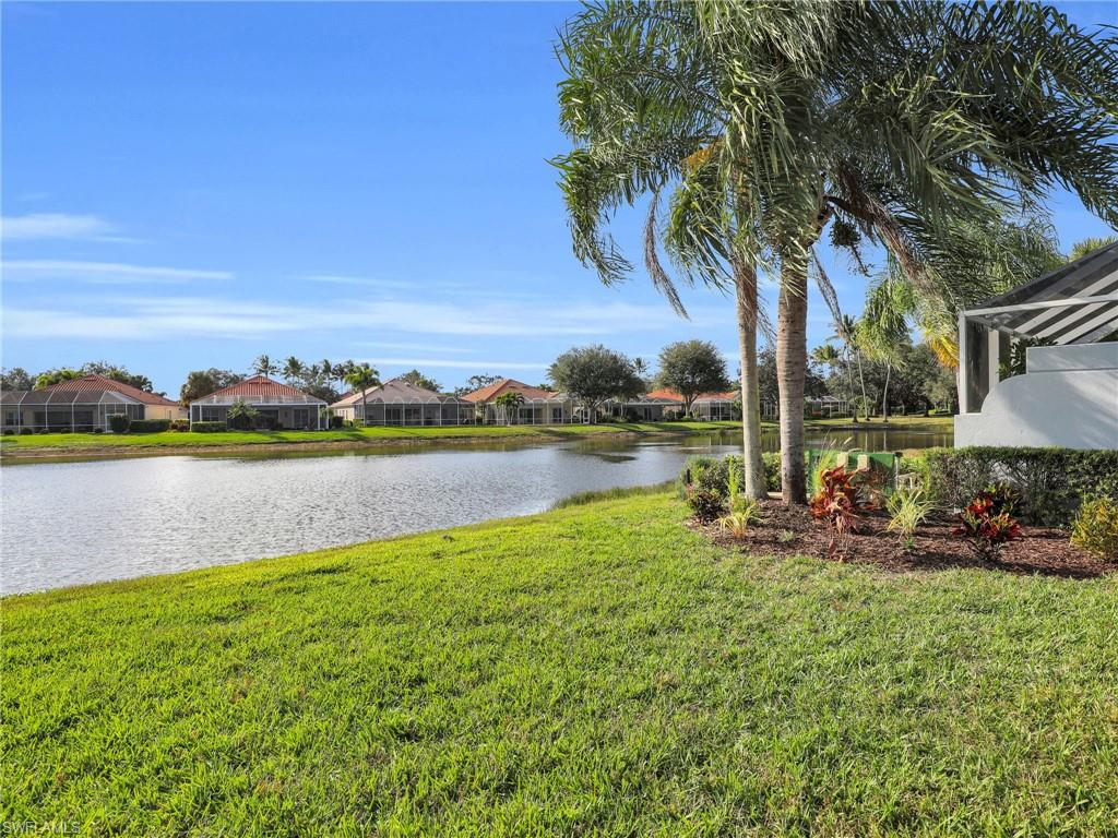 4231 Redonda Lane Naples, FL 34119 - Photo 23 of 42 a view of a lake with houses in the back