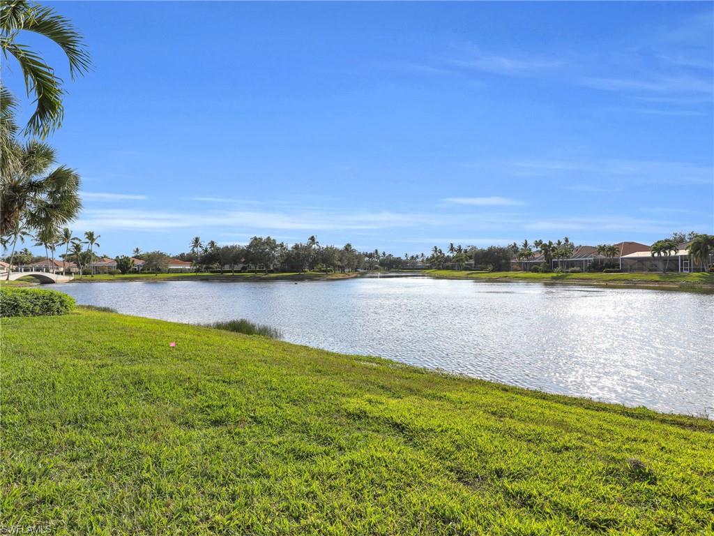 4231 Redonda Lane Naples, FL 34119 - Photo 24 of 42 a view of a lake with houses in the back