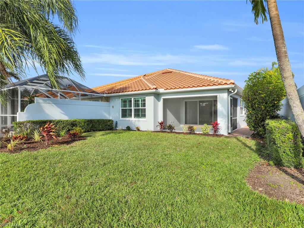 4231 Redonda Lane Naples, FL 34119 - Photo 25 of 42 a front view of a house with a garden