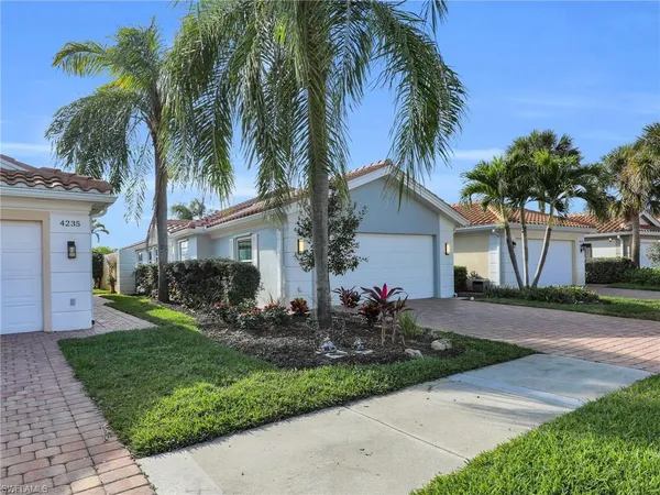 a front view of house with yard and green space