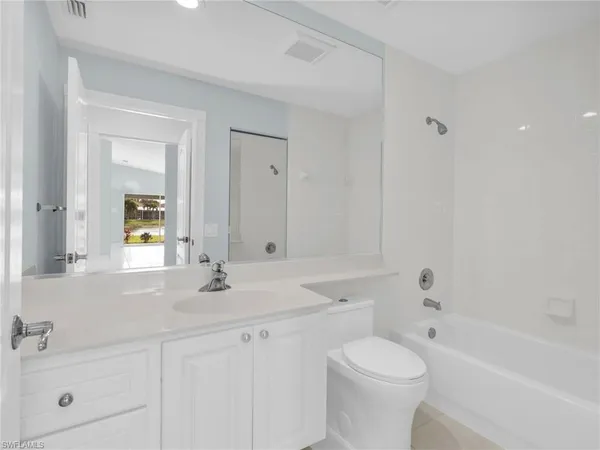 a utility room with cabinets washer and dryer