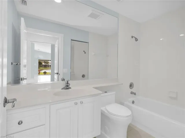 a utility room with cabinets washer and dryer