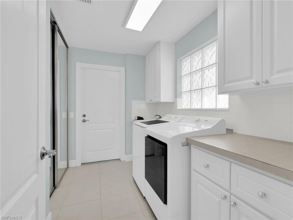 4231 Redonda Lane Naples, FL 34119 - Photo 32 of 42 a utility room with cabinets washer and dryer