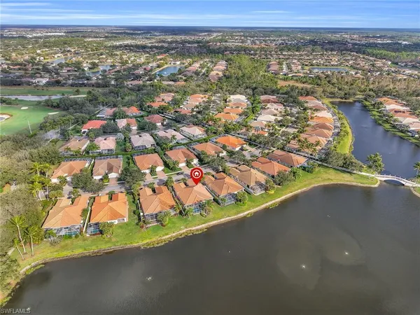 an aerial view of lake and residential houses with outdoor space and lake view