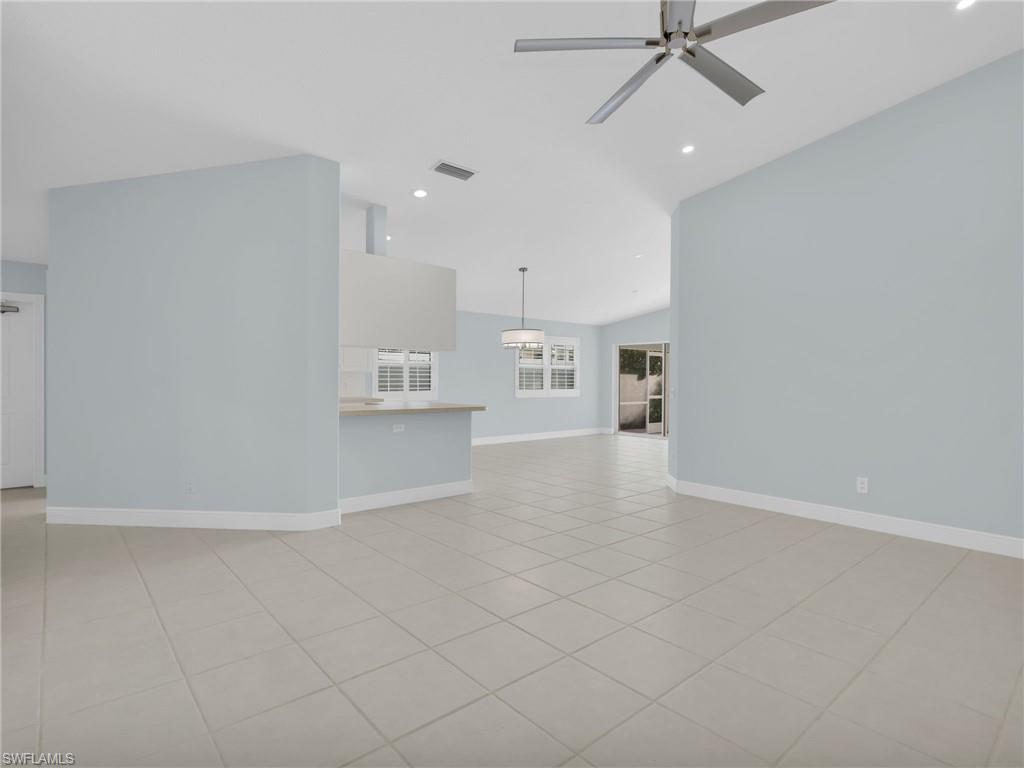 4231 Redonda Lane Naples, FL 34119 - Photo 9 of 42 an empty room with kitchen view and a window