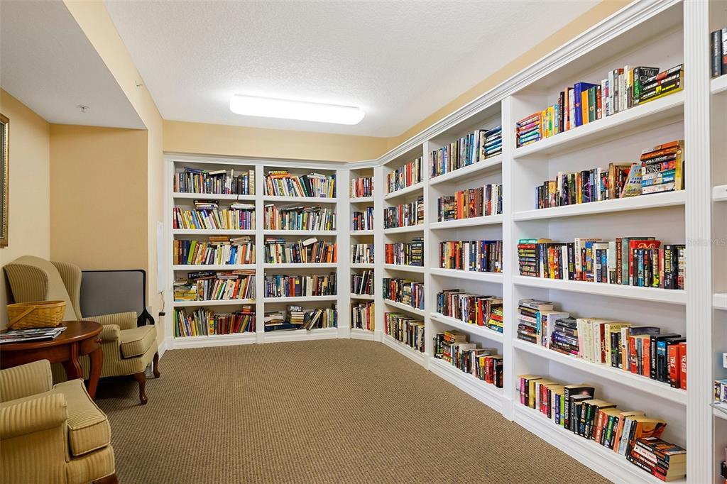 4516 Seagull Drive, Unit 810 New Port Richey, FL 34652 - Photo 14 of 54 a view of room with bookshelf and large window