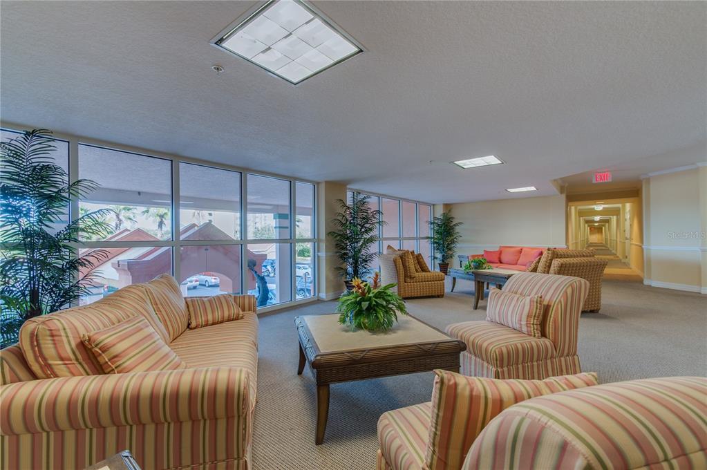 4516 Seagull Drive, Unit 810 New Port Richey, FL 34652 - Photo 18 of 54 a living room with furniture and a floor to ceiling window