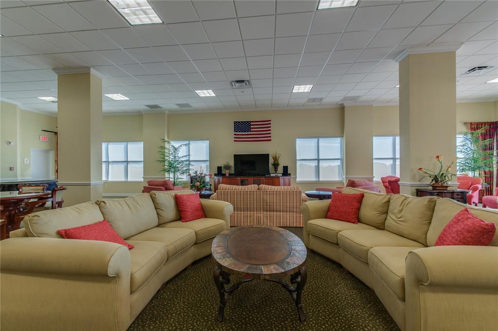 4516 Seagull Drive, Unit 810 New Port Richey, FL 34652 - Photo 19 of 54 a living room with furniture and a couch
