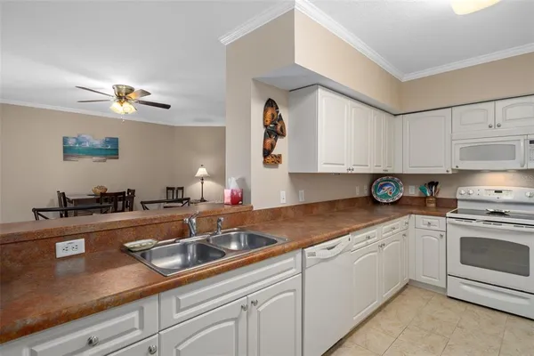 a living room with furniture a chandelier and a flat screen tv