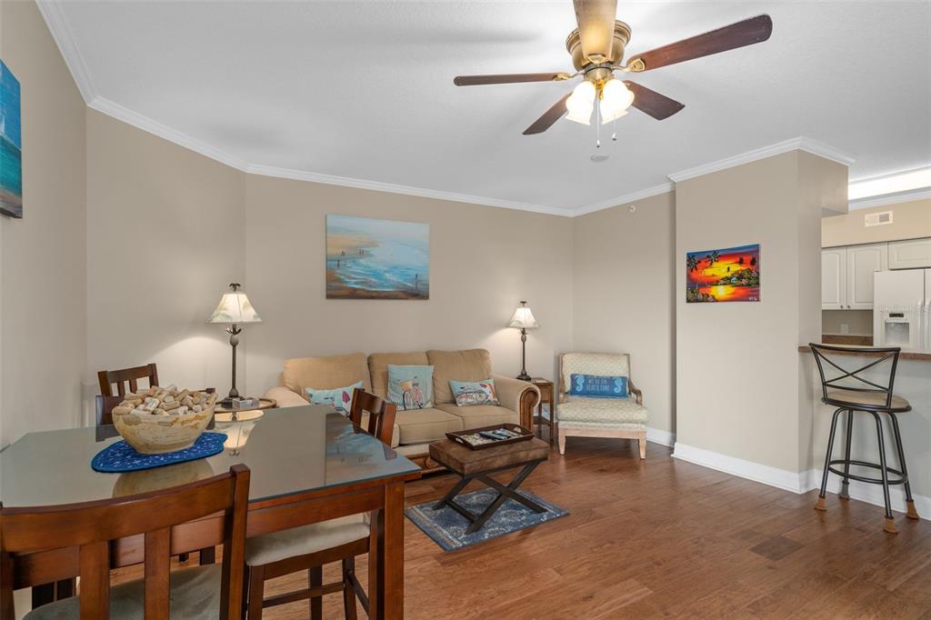 4516 Seagull Drive, Unit 810 New Port Richey, FL 34652 - Photo 34 of 54 a living room with furniture a chandelier and a flat screen tv