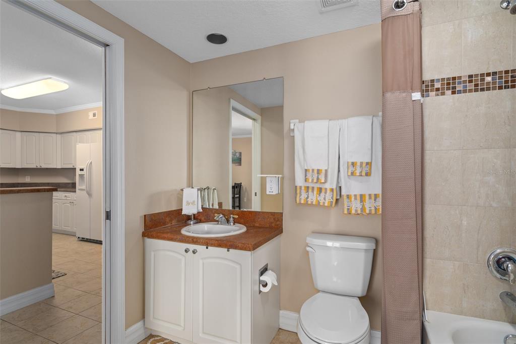 4516 Seagull Drive, Unit 810 New Port Richey, FL 34652 - Photo 37 of 54 a bathroom with a toilet a sink and mirror