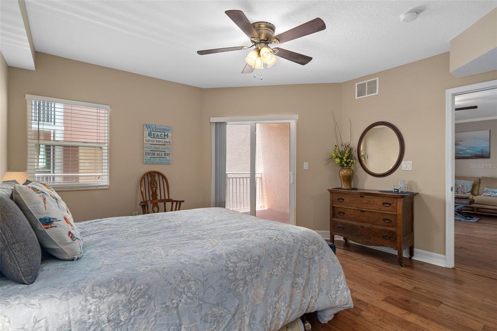 4516 Seagull Drive, Unit 810 New Port Richey, FL 34652 - Photo 39 of 54 a bedroom with a bed and a chandelier