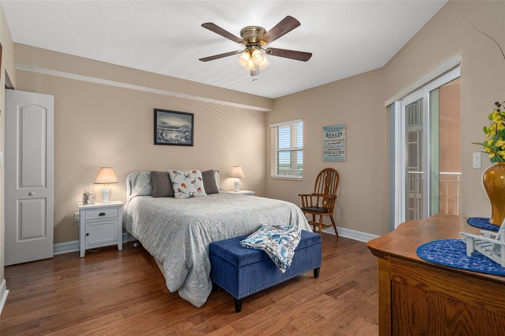 4516 Seagull Drive, Unit 810 New Port Richey, FL 34652 - Photo 40 of 54 a bedroom with a bed and a chandelier