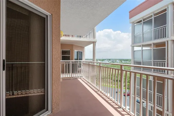 a view of balcony with a floor to ceiling window and wooden floor