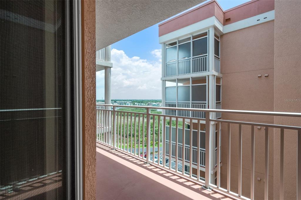 4516 Seagull Drive, Unit 810 New Port Richey, FL 34652 - Photo 46 of 54 a view of balcony with a floor to ceiling window and wooden floor