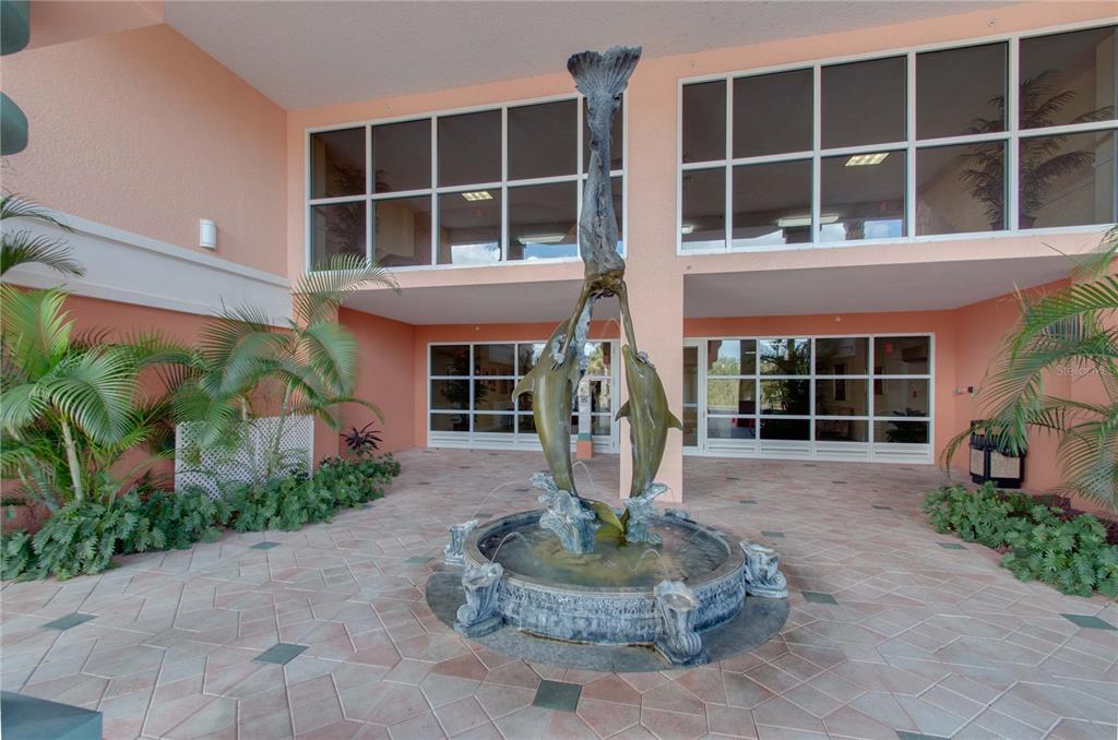 4516 Seagull Drive, Unit 810 New Port Richey, FL 34652 - Photo 5 of 54 a front view of a house with a yard and potted plants