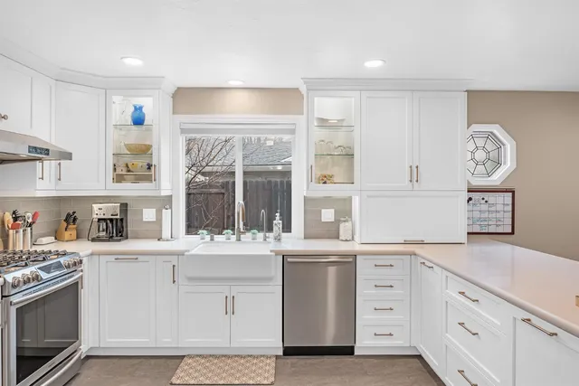 a kitchen with a sink stove and cabinets