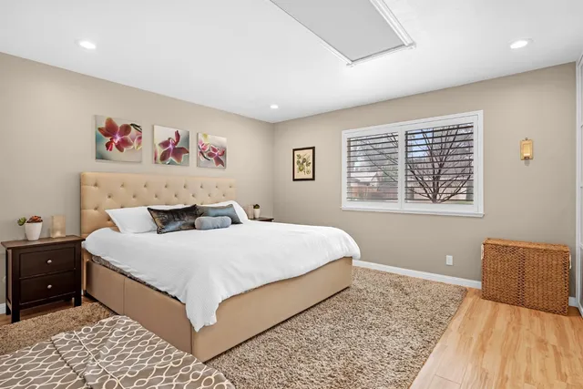 a bedroom with a large bed and a window