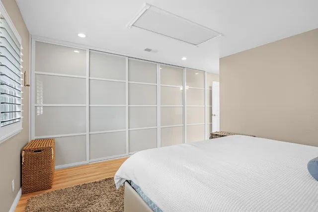 a bedroom with a bed and chair