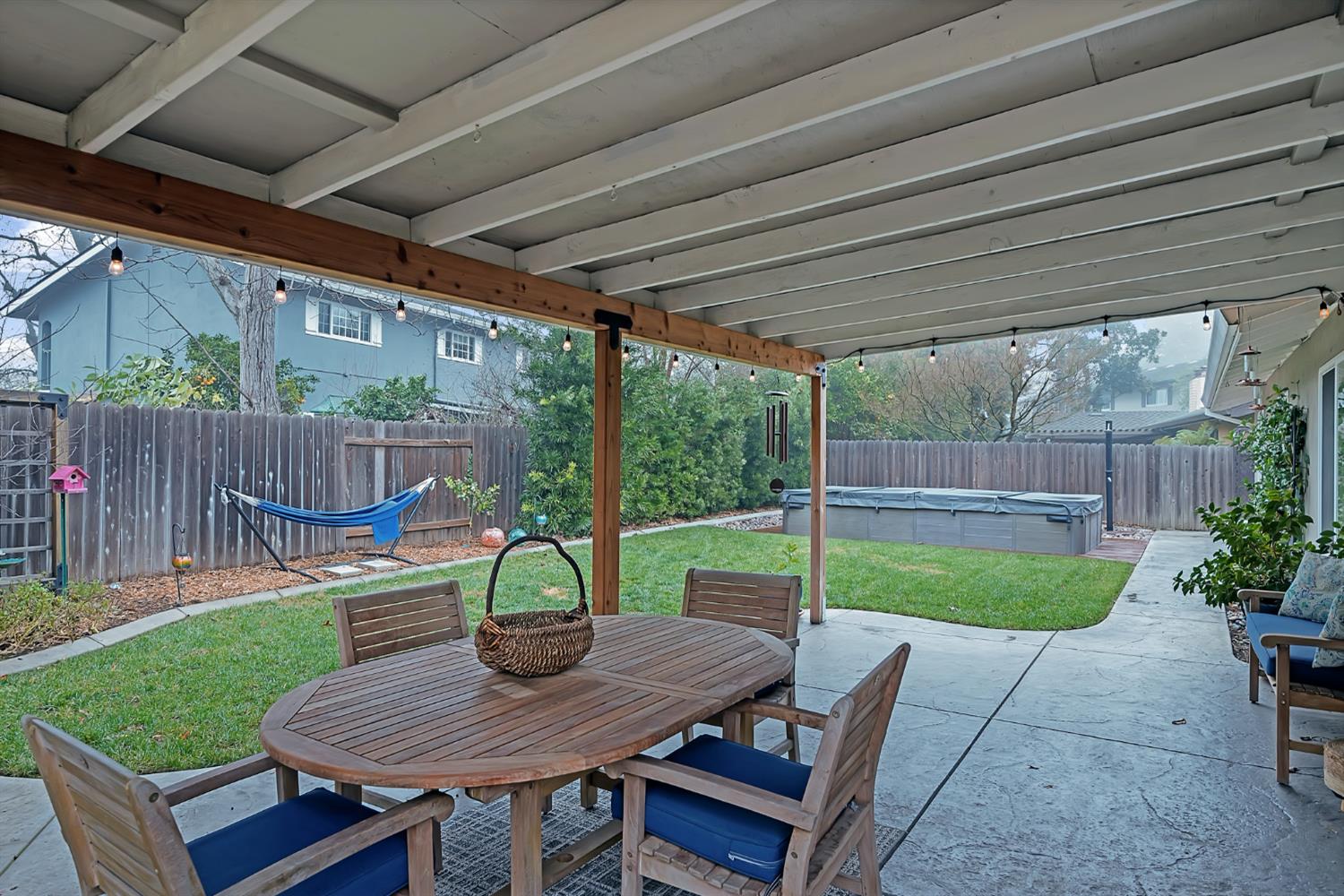 5220 Shelato Way Carmichael, CA 95608 - Photo 30 of 40 a view of a deck with a table chairs and a backyard