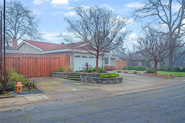 a front view of a house with yard and green space