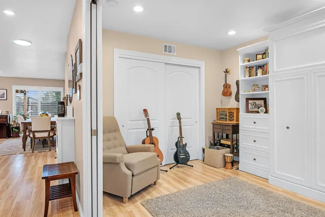 a living room with furniture closet and a flat screen tv