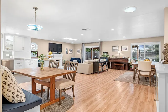 a living room with furniture and kitchen view