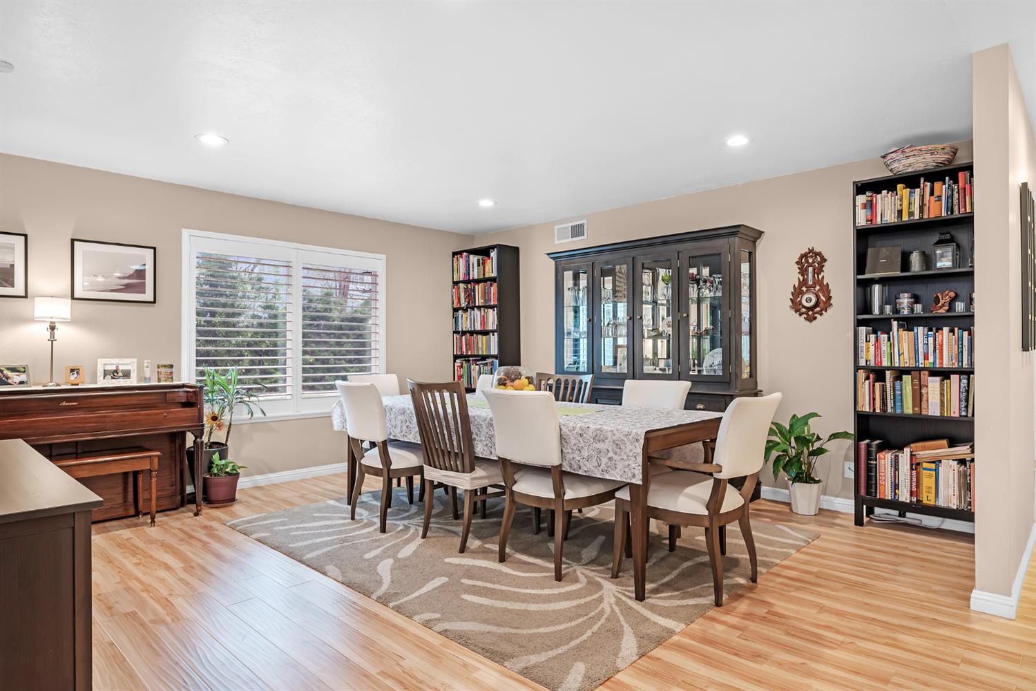5220 Shelato Way Carmichael, CA 95608 - Photo 7 of 40 a dining room with wooden floor and a book shelf