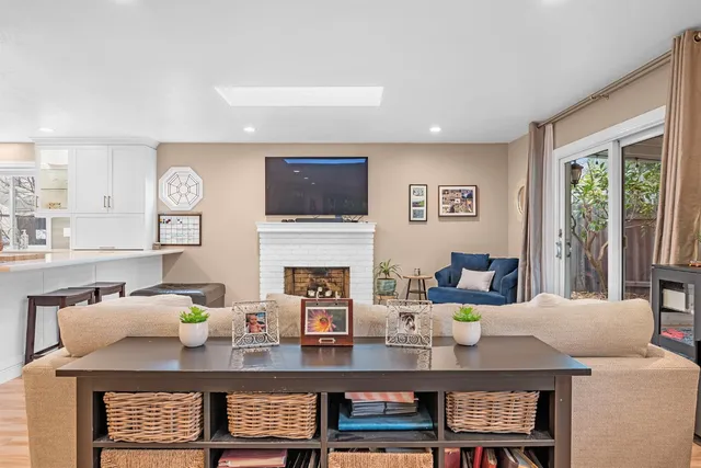 a living room with fireplace furniture and a flat screen tv