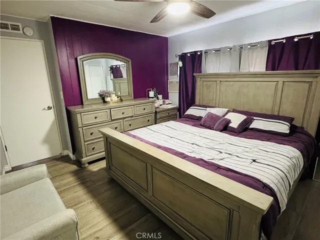 a bedroom with a bed and a mirror on dresser