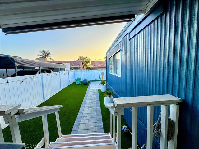 a view of a backyard with wooden fence