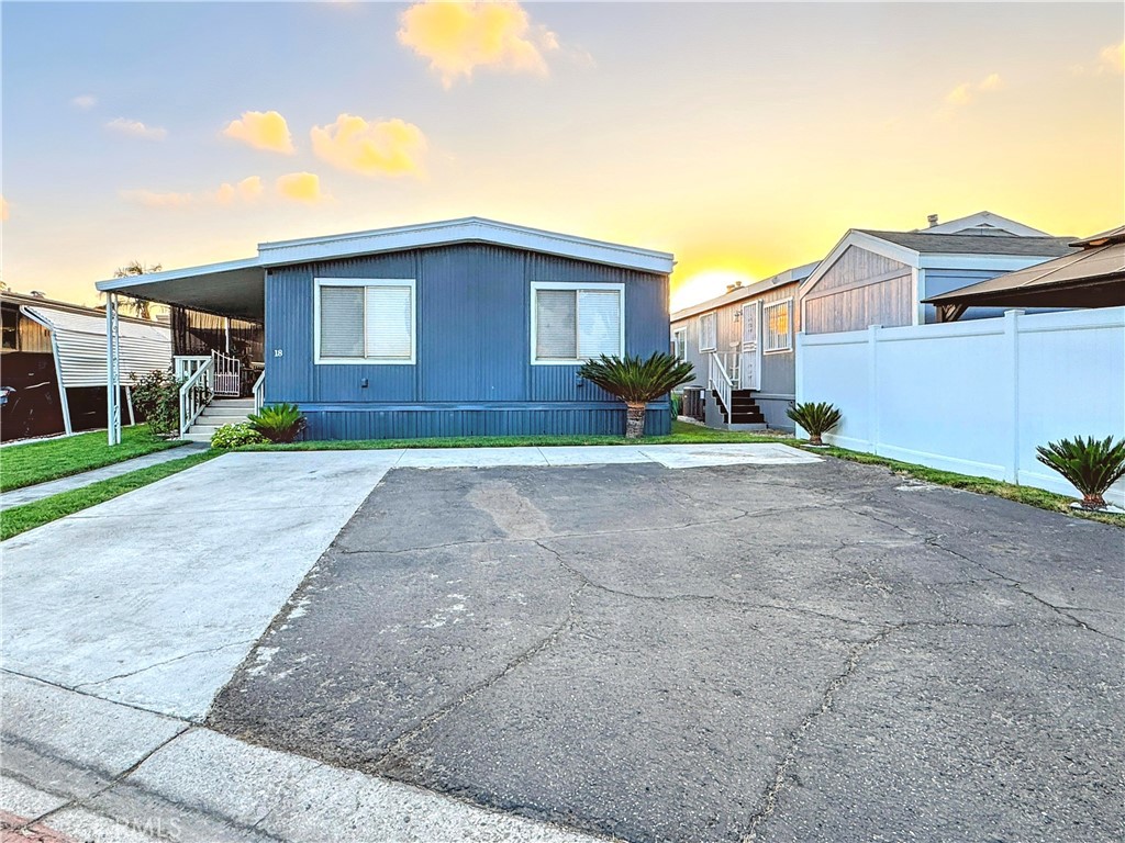 26245 East Baseline Street, Unit 18 Highland, CA 92346 - Photo 2 of 25 a view of a house with a yard