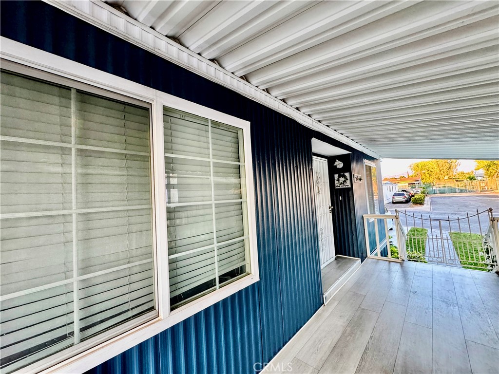 26245 East Baseline Street, Unit 18 Highland, CA 92346 - Photo 22 of 25 a view of a balcony with wooden floor