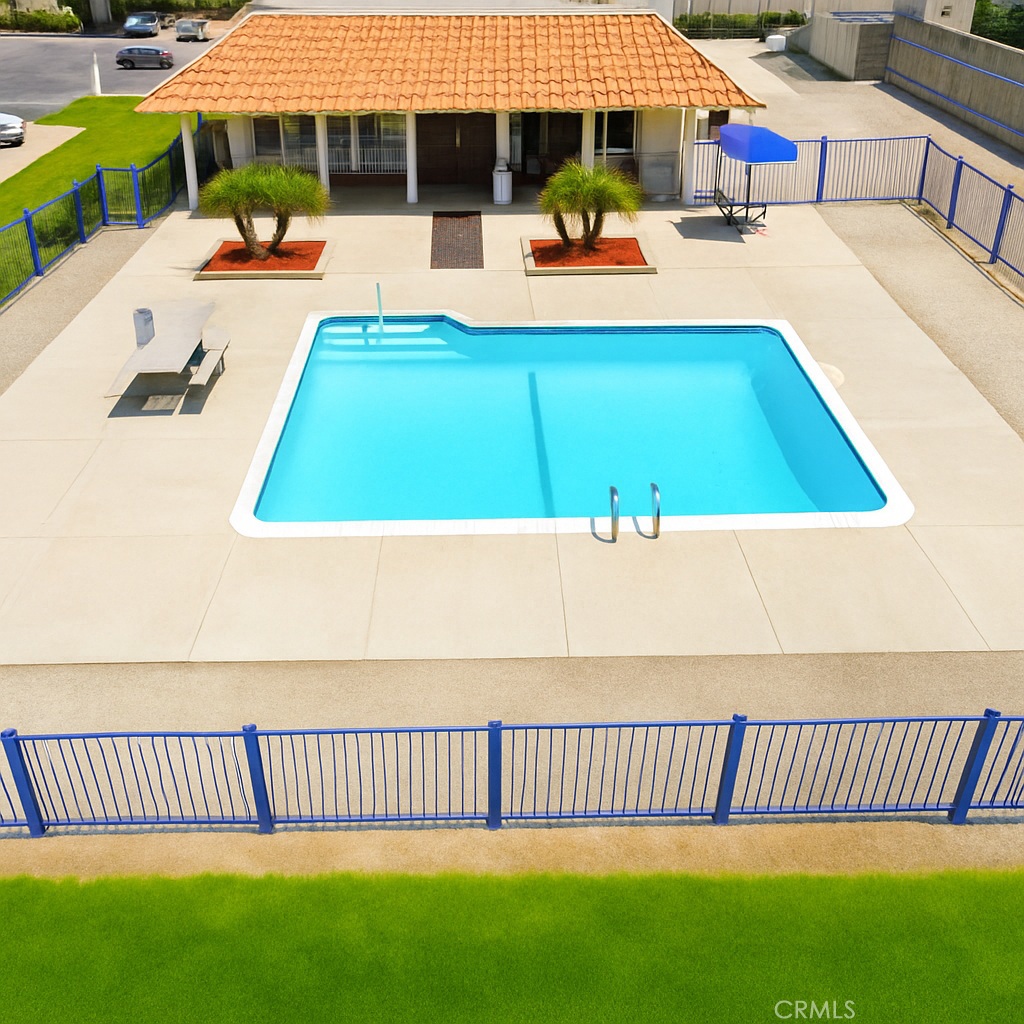 26245 East Baseline Street, Unit 18 Highland, CA 92346 - Photo 24 of 25 a view of a swimming pool with a patio