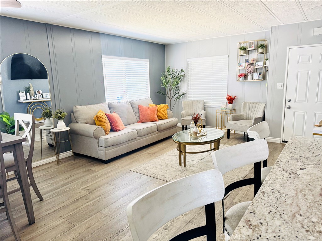 26245 East Baseline Street, Unit 18 Highland, CA 92346 - Photo 4 of 25 a living room with furniture and a wooden floor