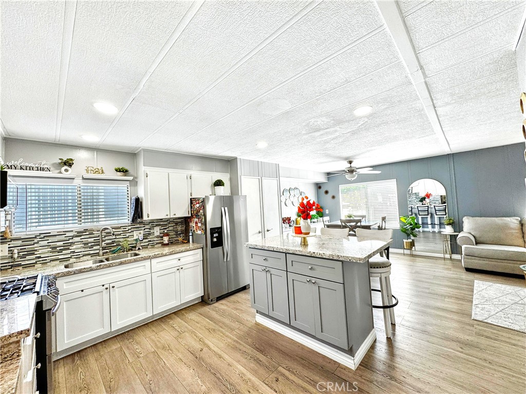 26245 East Baseline Street, Unit 18 Highland, CA 92346 - Photo 7 of 25 a kitchen with a sink stove and cabinets