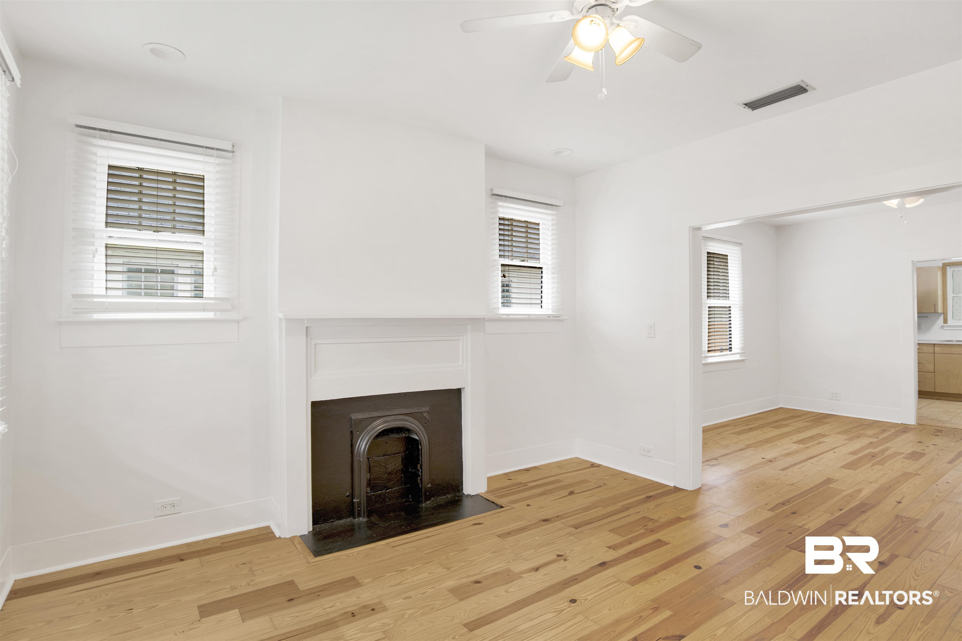 507 Holcombe Avenue Mobile, AL 36606 - Photo 21 of 28 Unfurnished living room with light wood finished floors, baseboards, and healthy amount of natural light
