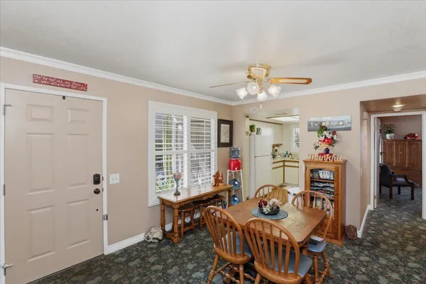 a bedroom with furniture and a large window