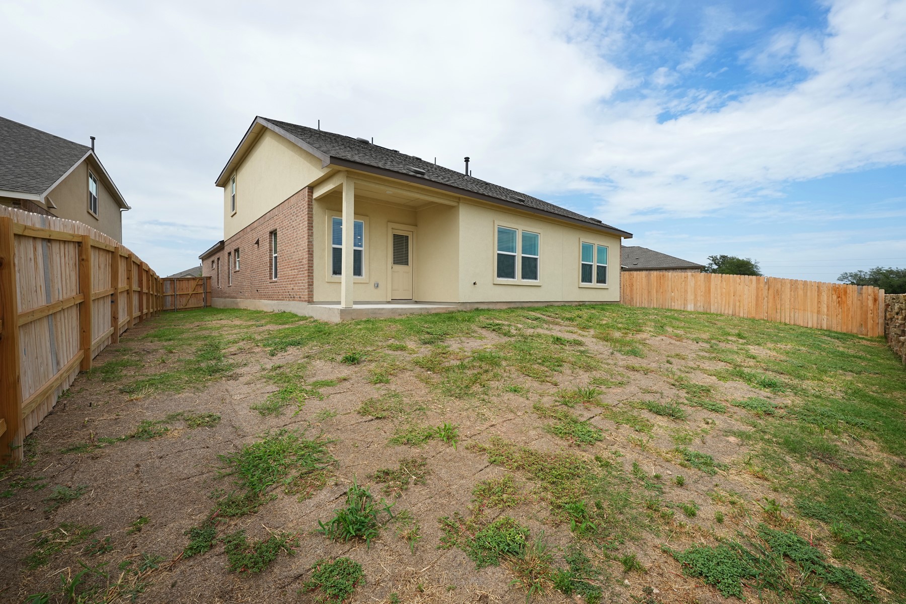 932 Mallow Road Leander, TX 78641 - Photo 31 of 34 A spacious backyard awaits, fully fenced for privacy and outdoor enjoyment.