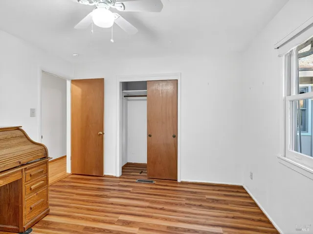 a kitchen with granite countertop a refrigerator stove and cabinets