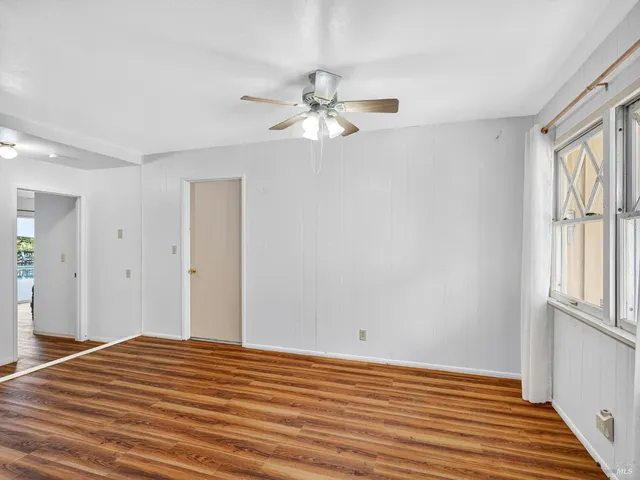 a view of backyard with wooden floor and fence