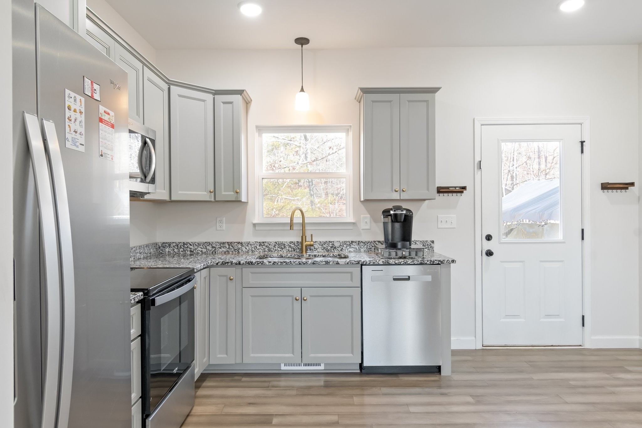 2800 North Hurricane Creek Road McEwen, TN 37101 - Photo 12 of 36 a kitchen with stainless steel appliances granite countertop a stove a sink and a refrigerator