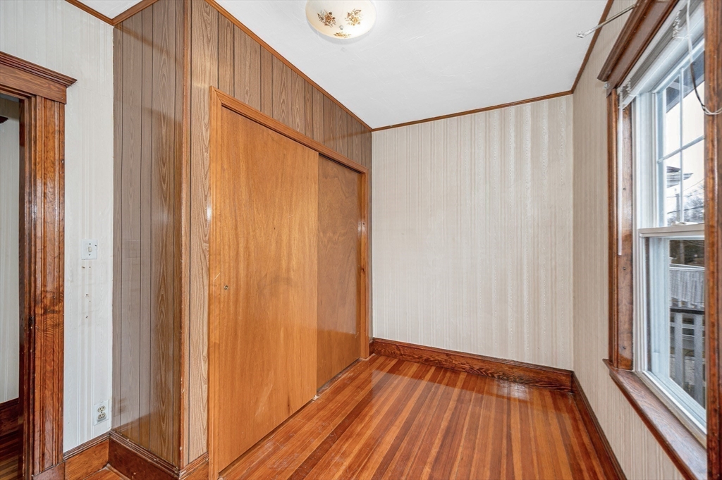 481 Lagrange Street Boston, MA 02132 - Photo 10 of 32 a view of a room with wooden floor and a window