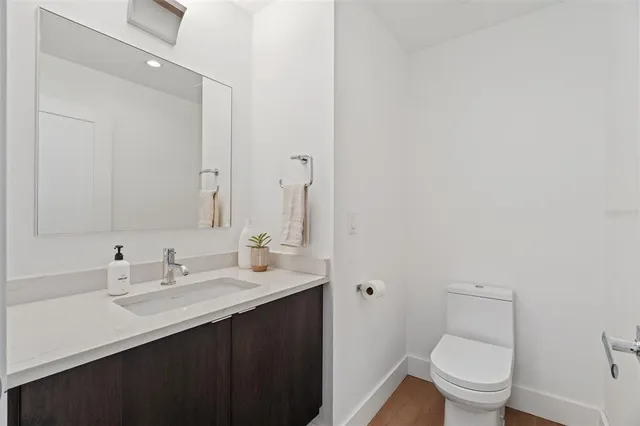 a bathroom with a sink toilet and a mirror