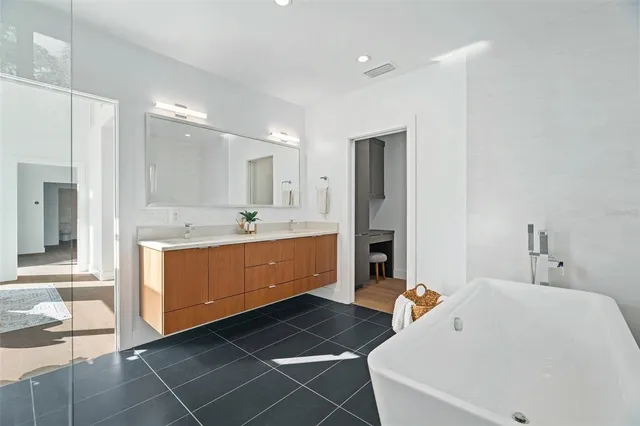 a bathroom with a bathtub and a window